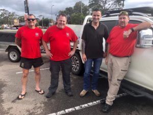 Animal Evac volunteers standing in a car park by a four wheel drive